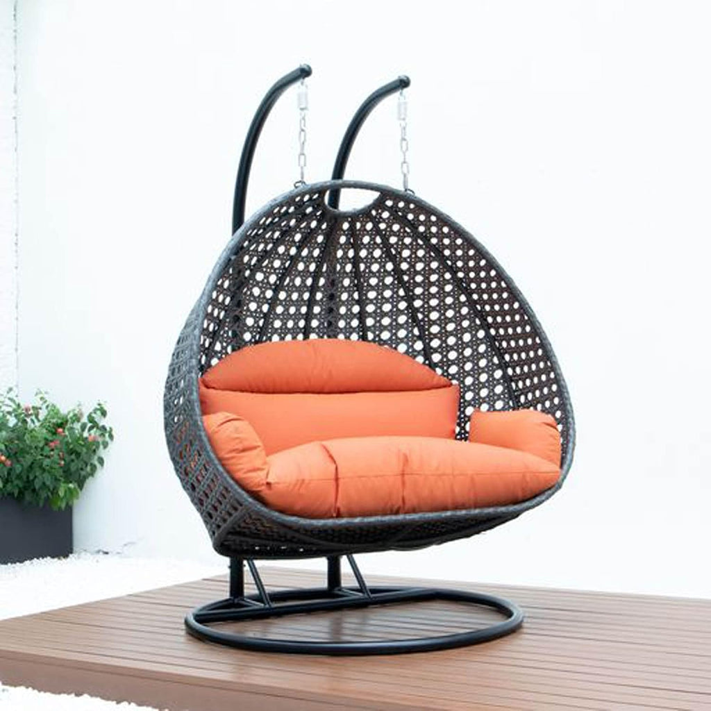 LeisureMod 2 Person Wicker Hanging Egg Chair, Indoor Outdoor Patio Swing with Black Stand & UV-Resistant Cushions, Lounge Chair for Bedroom & Garden, Orange