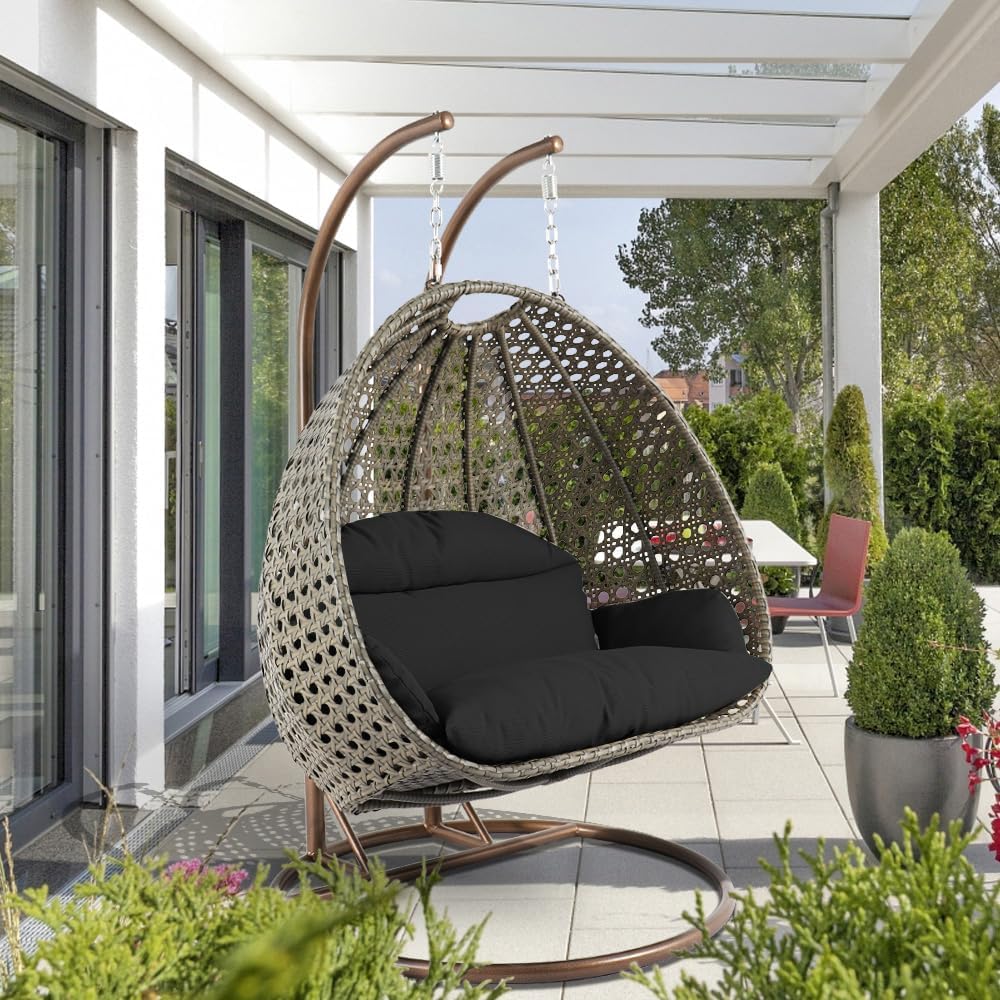 LeisureMod Black Wicker 2 Person Egg Swing Chair with Beige Stand and Cushions – Double Hanging Hammock Lounge for Patio, Indoor & Outdoor Use