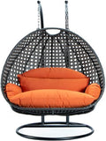 LeisureMod 2 Person Wicker Hanging Egg Chair, Indoor Outdoor Patio Swing with Black Stand & UV-Resistant Cushions, Lounge Chair for Bedroom & Garden, Orange