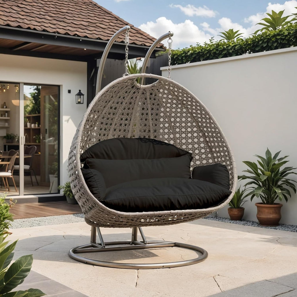 LeisureMod Black Wicker 2 Person Egg Swing Chair with Beige Stand and Cushions – Double Hanging Hammock Lounge for Patio, Indoor & Outdoor Use