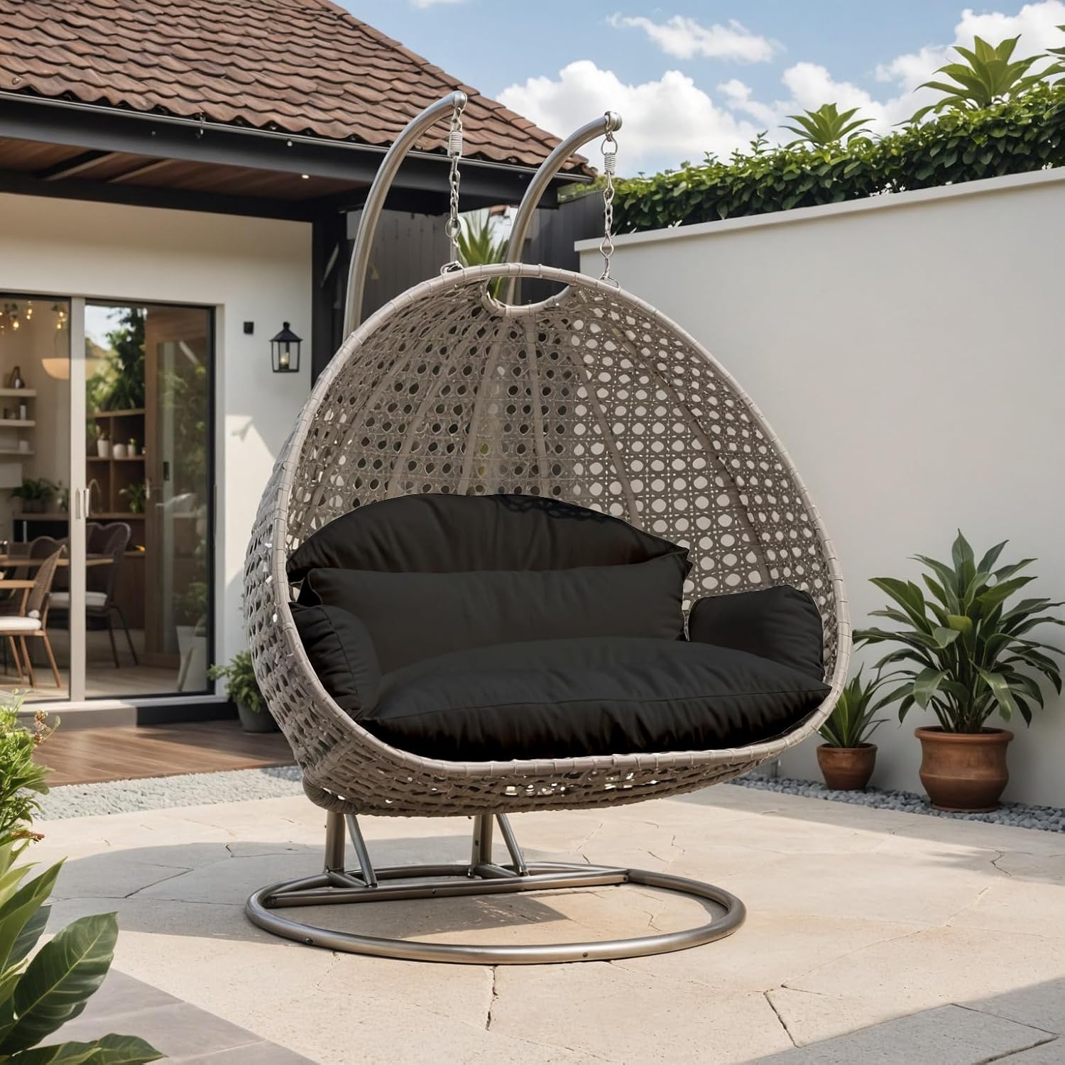 LeisureMod Black Wicker 2 Person Egg Swing Chair with Beige Stand and Cushions – Double Hanging Hammock Lounge for Patio, Indoor & Outdoor Use