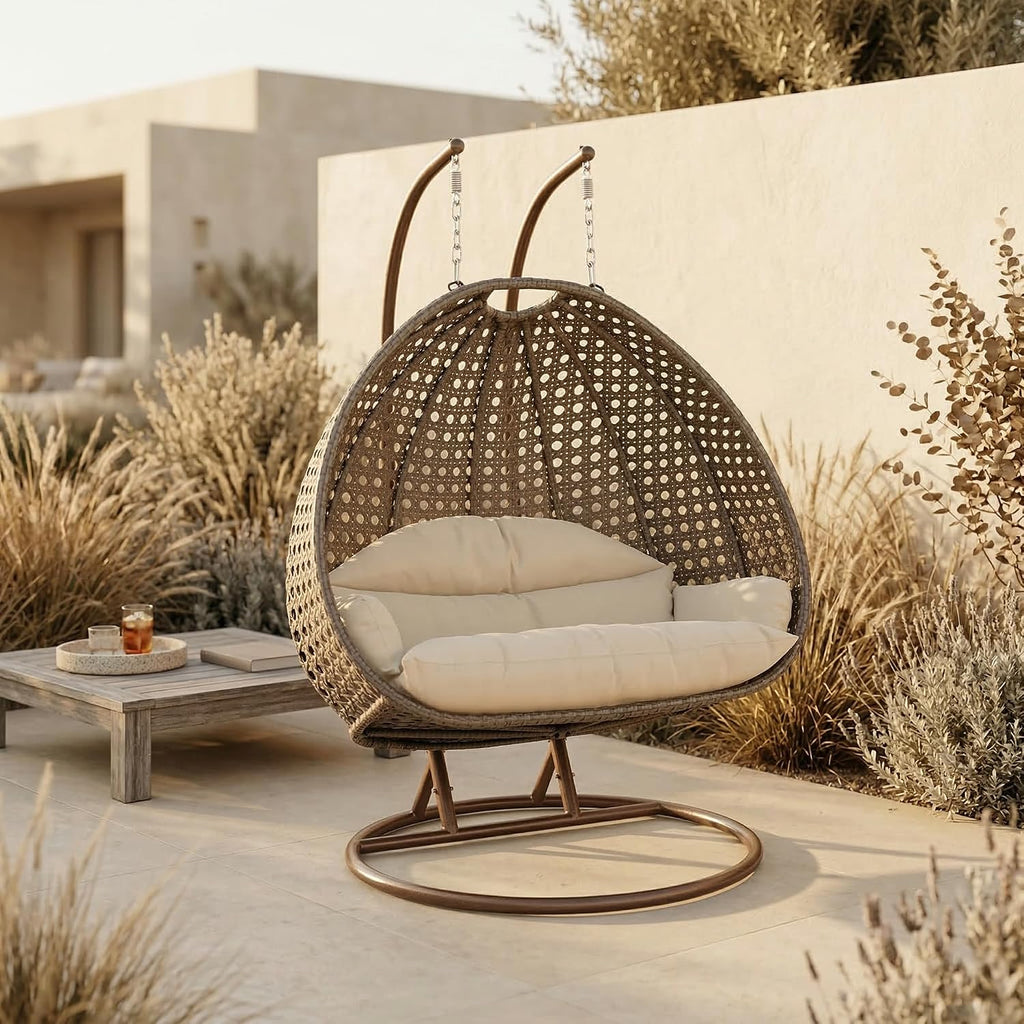 LeisureMod 2-Person Wicker Egg Chair, Hanging Swing Chair for Indoor & Outdoor Use with Cushions, Beige Steel Stand, UV-Resistant, Hammock Lounge Seat for Patio, Porch, or Bedroom (Cream)